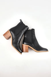 A model wearing size 37 of the Chai Leather Ankle Boot in colour Black (Black), from the front, showing the whole outfit