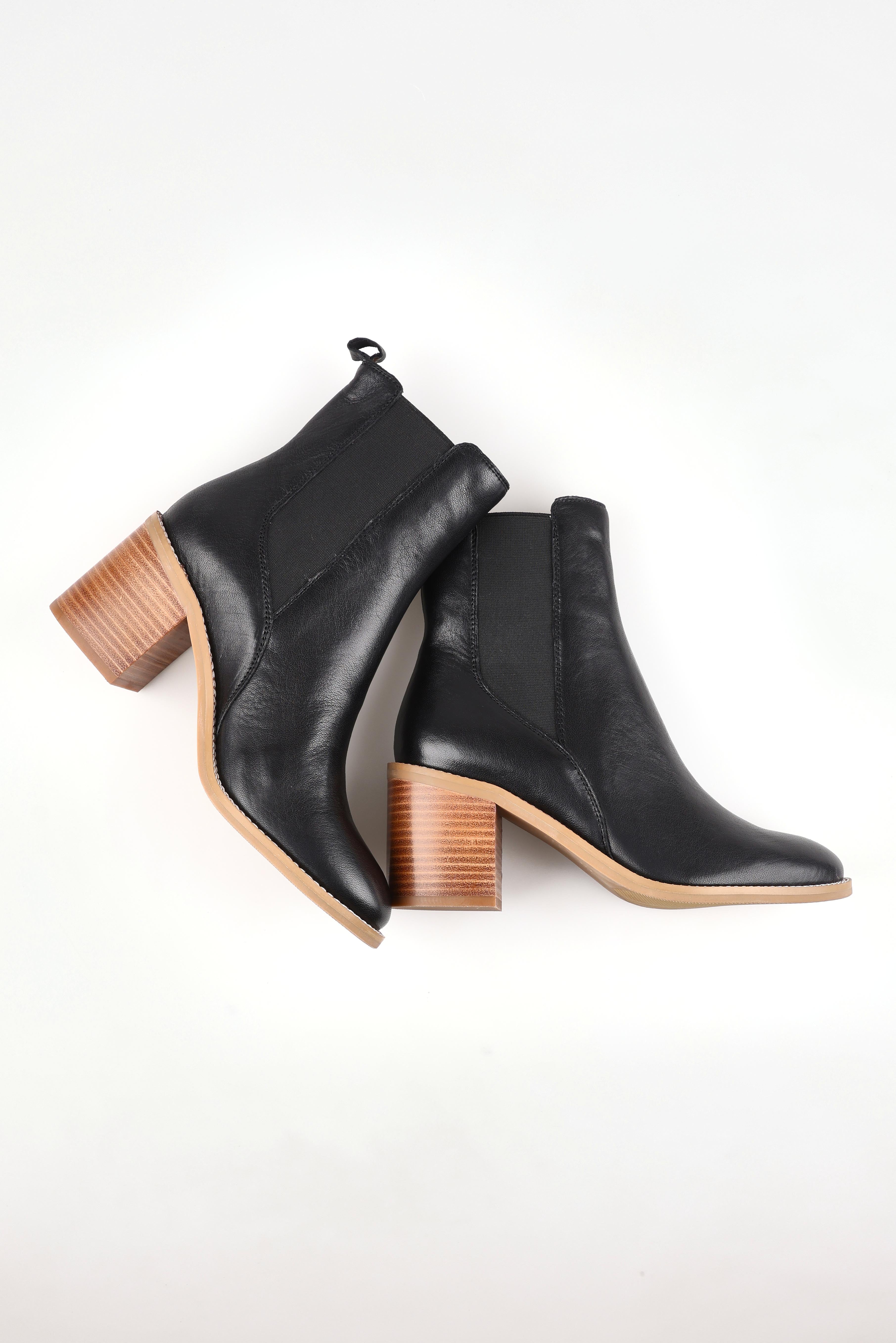 A model wearing size 37 of the Chai Leather Ankle Boot in colour Black (Black), from the front, showing the whole outfit