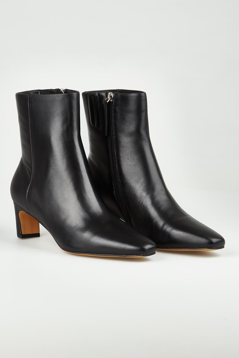 A model wearing size 37 of the Kitan Leather Ankle Boot in colour Black (Black), from the front, showing the whole outfit