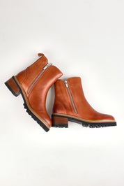 A model wearing size 37 of the Lindira Double Zip Leather Ankle Boot in colour Brandy, from the front, showing the whole outfit