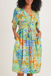 Model Ziara wearing size 10 of the Fiorella Waist Dress in colour Print, from the front, cropped image