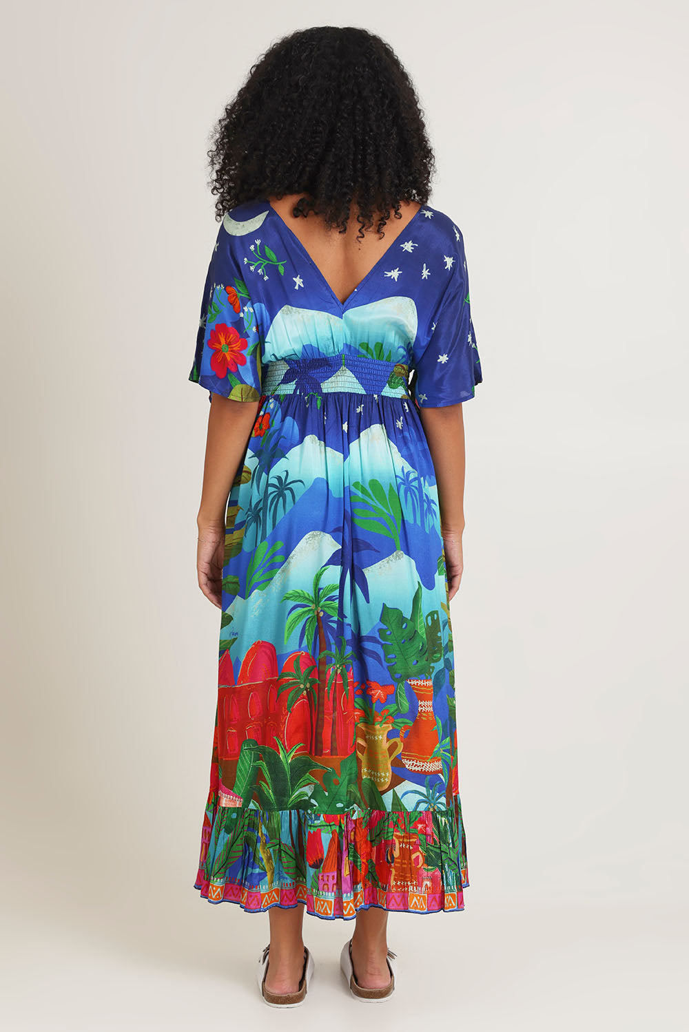 Model Ziara wearing size 10 of the Arabian Nights Shirred Waist Dress in colour Print, from the back