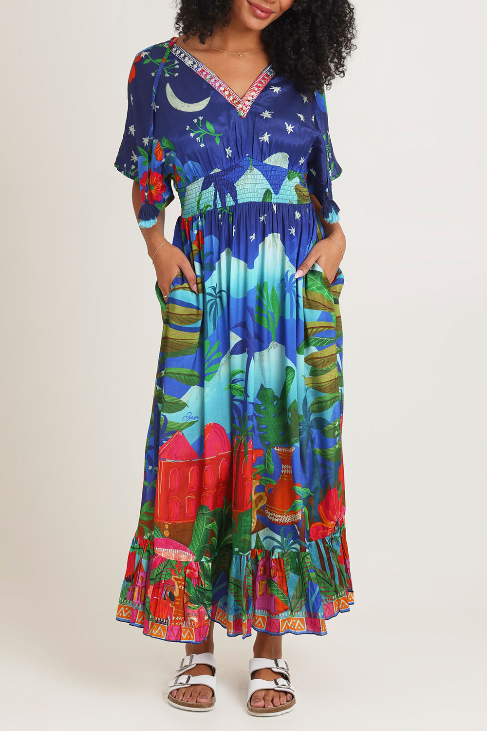 Model Ziara wearing size 10 of the Arabian Nights Shirred Waist Dress in colour Print, from the front, cropped image