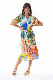 A model wearing the Sardinia Tie Waist Dress in colour Print, from the front, showing the whole outfit