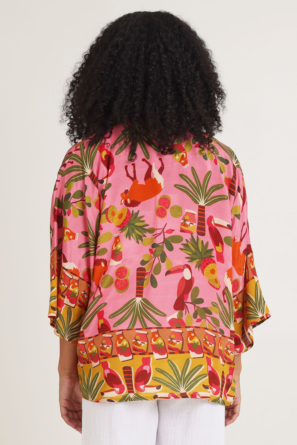 Model Ziara wearing size 10 of the Chaira Wrap in colour Print, from the back