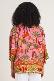 Model Ziara wearing size 10 of the Chaira Wrap in colour Print, from the back