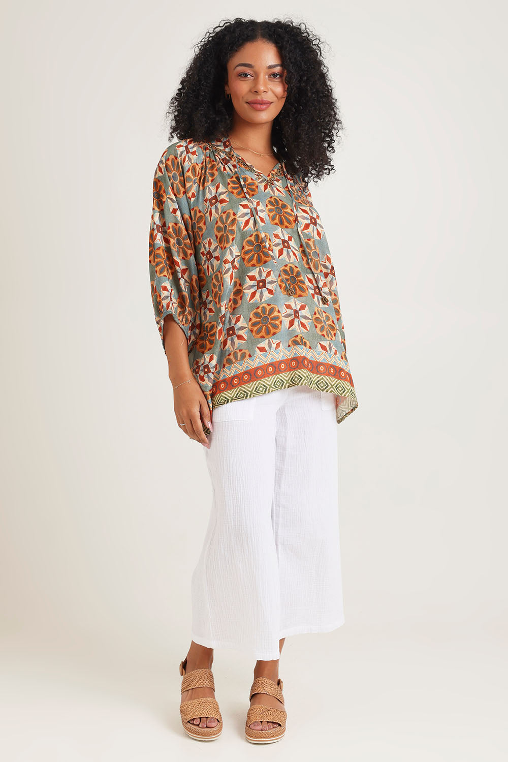Model Ziara wearing size 10 of the Vera Top in colour Print, from the front, showing the whole outfit