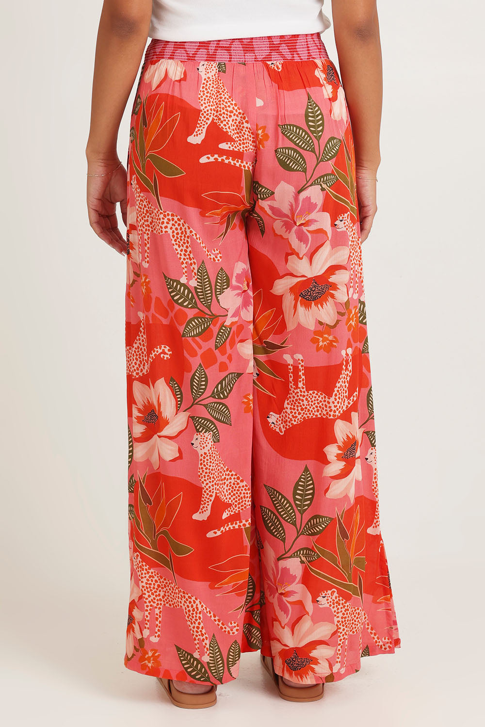 Model Ziara wearing size 10 of the Aria Pant in colour Print (Pink), from the back