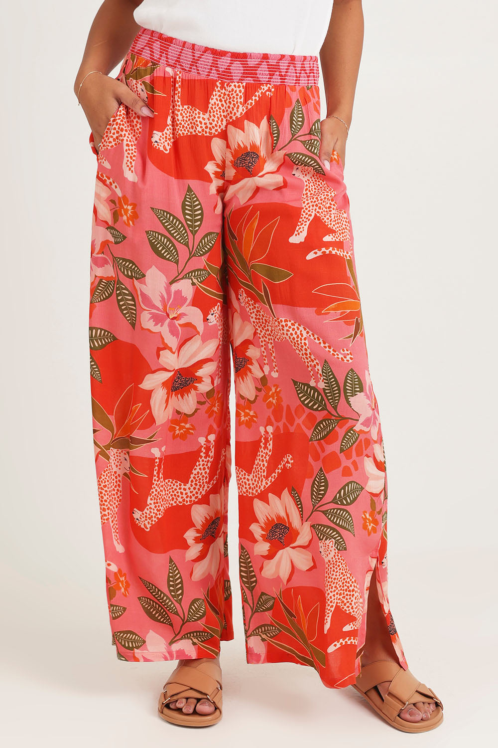 Model Ziara wearing size 10 of the Aria Pant in colour Print (Pink), from the front, cropped image