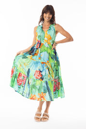 A model wearing the Evelyn Sleeveless Tie Dress in colour Print, from the front, showing the whole outfit