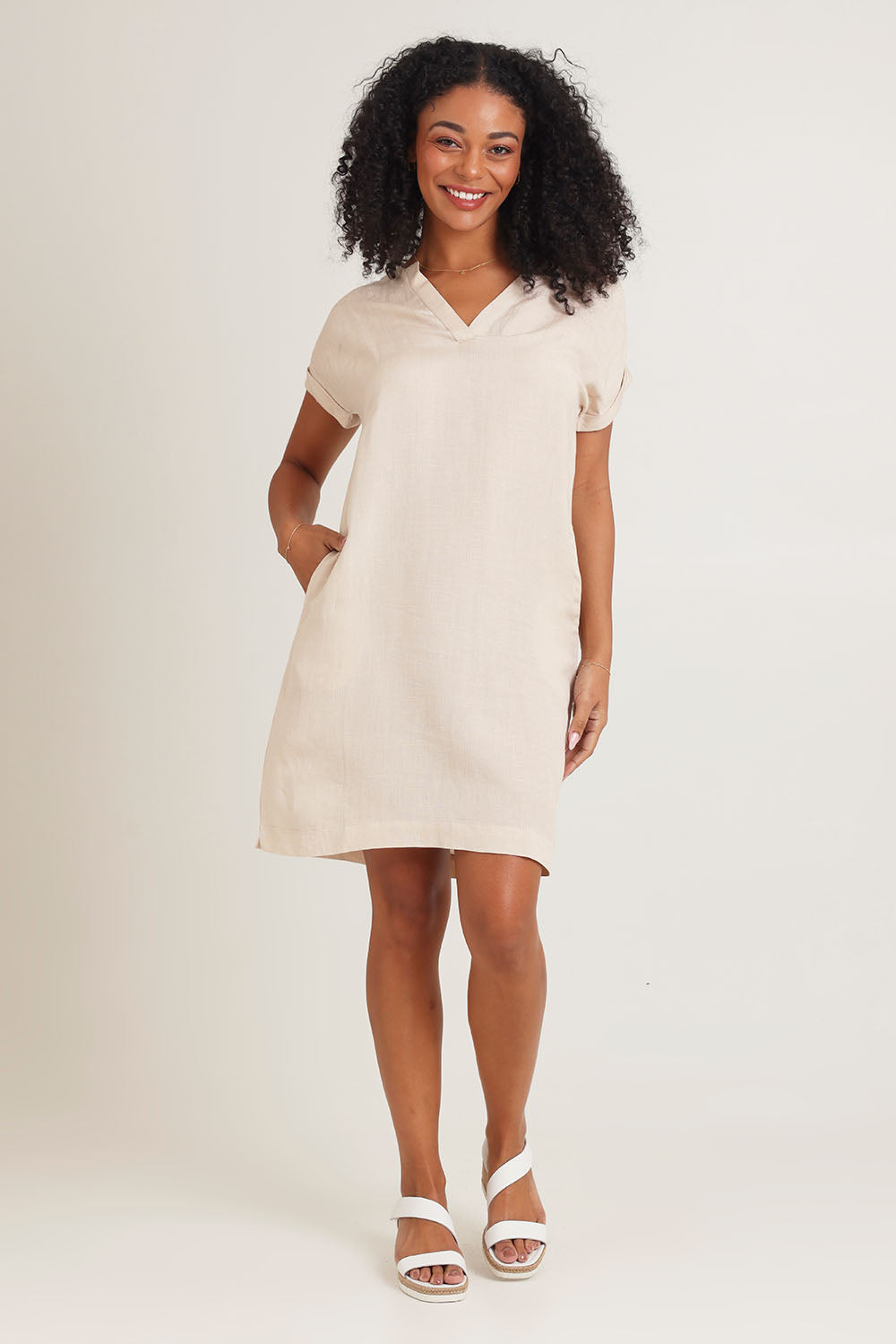 Model Ziara wearing size 10 of the Linen Blend Solid Shift Dress in colour Sand, from the front, showing the whole outfit