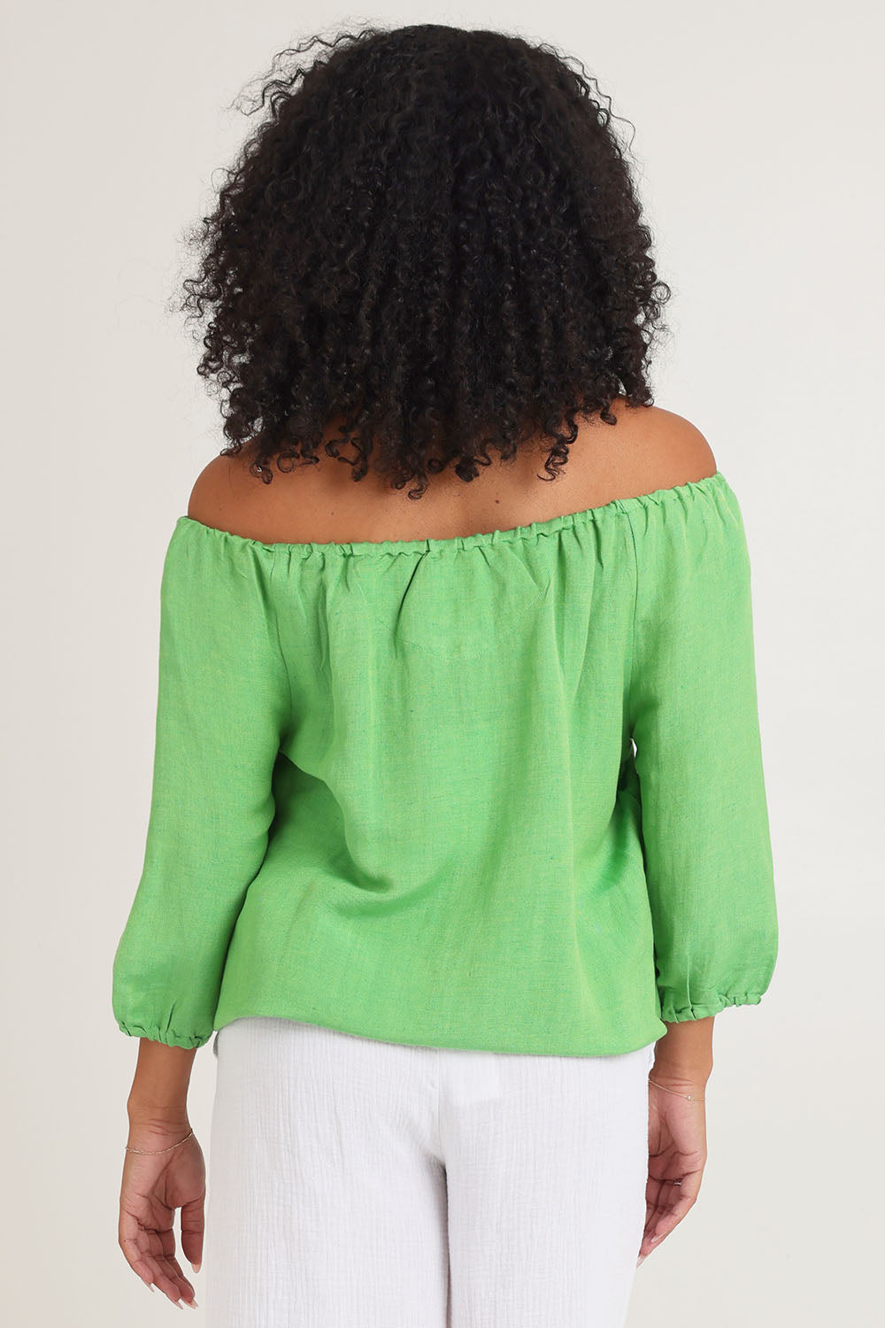 Model Ziara wearing size 10 of the Gather Neck 3/4 Sleeve Linen Blend Top in colour Green (Green), from the back