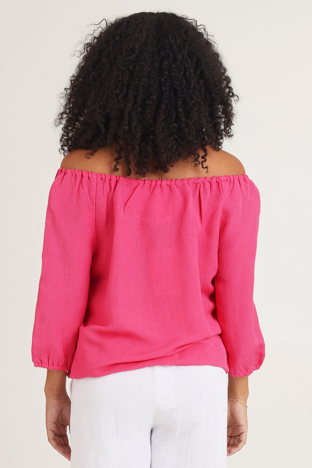 Model Ziara wearing size 10 of the Gather Neck 3/4 Sleeve Linen Blend Top in colour Hotpink (Blue), from the back