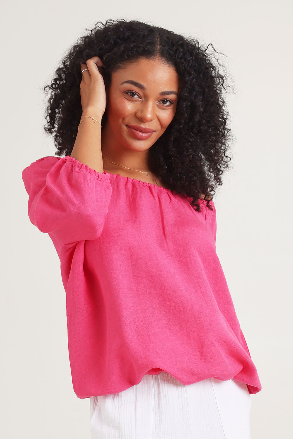 Model Ziara wearing size 10 of the Gather Neck 3/4 Sleeve Linen Blend Top in colour Hotpink (Blue), from the front, cropped image