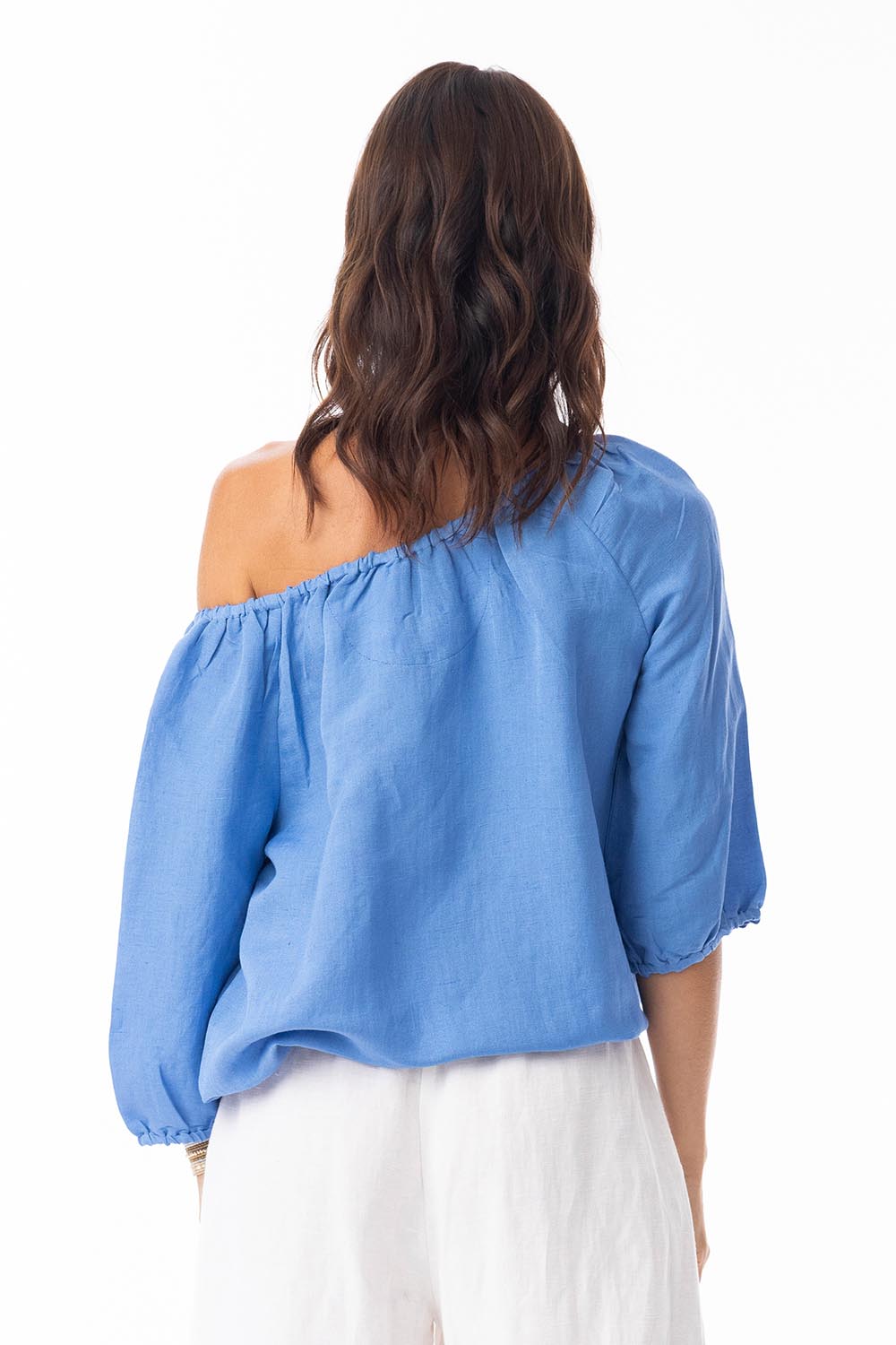A model wearing the Gather Neck 3/4 Sleeve Linen Blend Top in colour Ibizablue (Blue), from the back