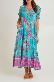 Model Madeline wearing size 10 of the Marina Maxi Dress in colour Print (Blue), from the front, cropped image