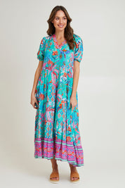 Model Madeline wearing size 10 of the Marina Maxi Dress in colour Print (Blue), from the front, showing the whole outfit