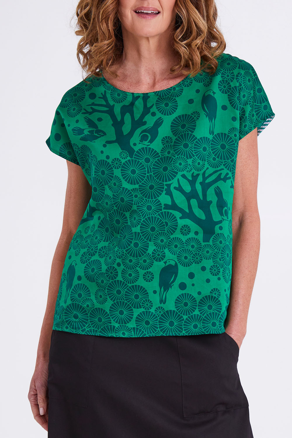 Model Emma wearing size S of the Mikko Tilly Top in colour Emerald (Green), from the front, cropped image