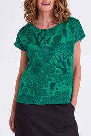 Model Emma wearing size S of the Mikko Tilly Top in colour Emerald (Green), from the front, cropped image