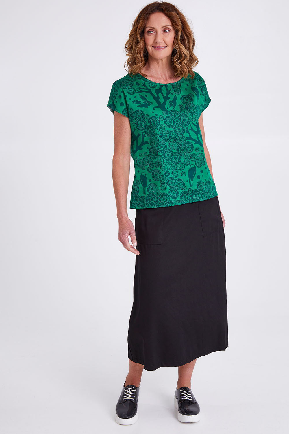 Model Emma wearing size S of the Mikko Tilly Top in colour Emerald (Green), from the front, showing the whole outfit