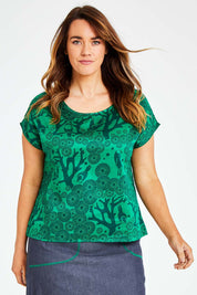 Model Laura wearing size L of the Mikko Tilly Top in colour Emerald (Green), from the front, cropped image