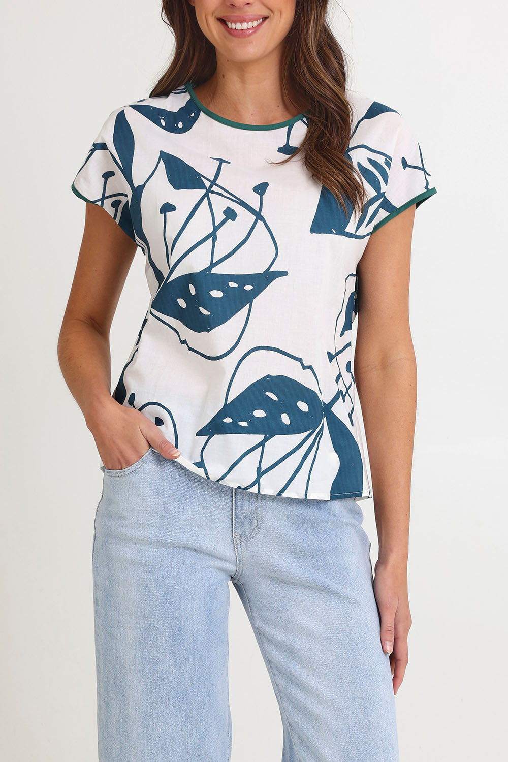 Model Madeline wearing size S of the Tilly Cotton Top in colour Articblue (Blue), from the front, cropped image