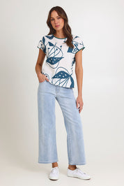 Model Madeline wearing size S of the Tilly Cotton Top in colour Articblue (Blue), from the front, showing the whole outfit