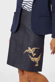 Model Cara wearing size S of the 2 Birds Denim Skirt in colour PuttyDenim (Blue), from the front, cropped image