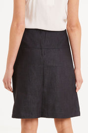 Model Madeline wearing size S of the 2 Birds Denim Skirt in colour PuttyDenim (Blue), from the back
