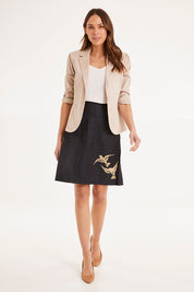 Model Madeline wearing size S of the 2 Birds Denim Skirt in colour PuttyDenim (Blue), from the front, showing the whole outfit