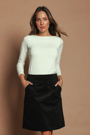 Model Madeline wearing size S of the Amy Cord Skirt in colour Black (Black), from the front, cropped image