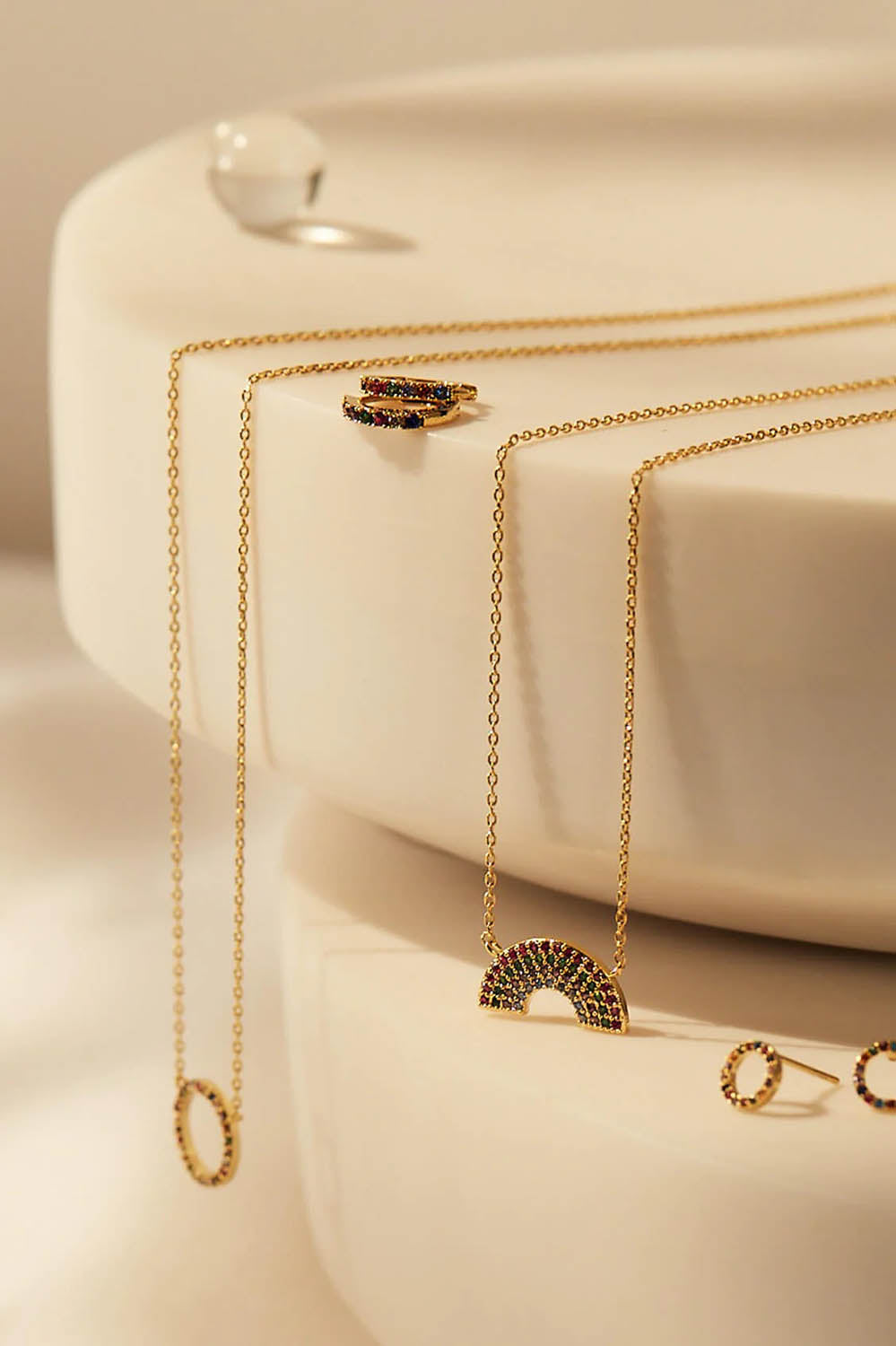 A model wearing the Full Rainbow Necklace in colour Gold (Metallics), from the front, showing the whole outfit