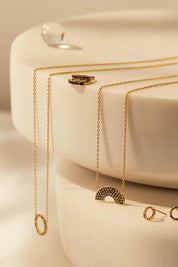 A model wearing the Full Rainbow Necklace in colour Gold (Metallics), from the front, showing the whole outfit