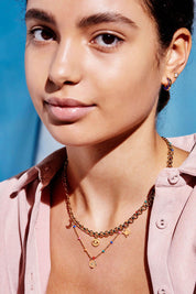 A model wearing the Beaded Rainbow Necklace in colour Gold (Metallics), from the front, showing the whole outfit