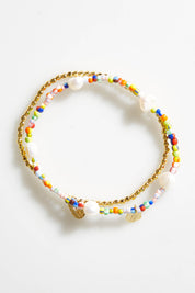 A model wearing size OneSize of the Gold & Multi Bracelet Set in colour Goldmulti (Metallics), from the front, showing the whole outfit