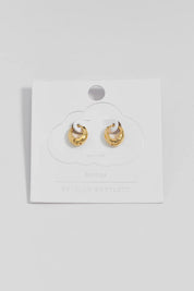 Product shot of the Hammered Huggie Hoops – Gold in colour Gold, from the front
