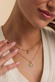 Model Genericm wearing size sample of the Hammered Coin Necklace – Gold in colour Gold, in a cropped view