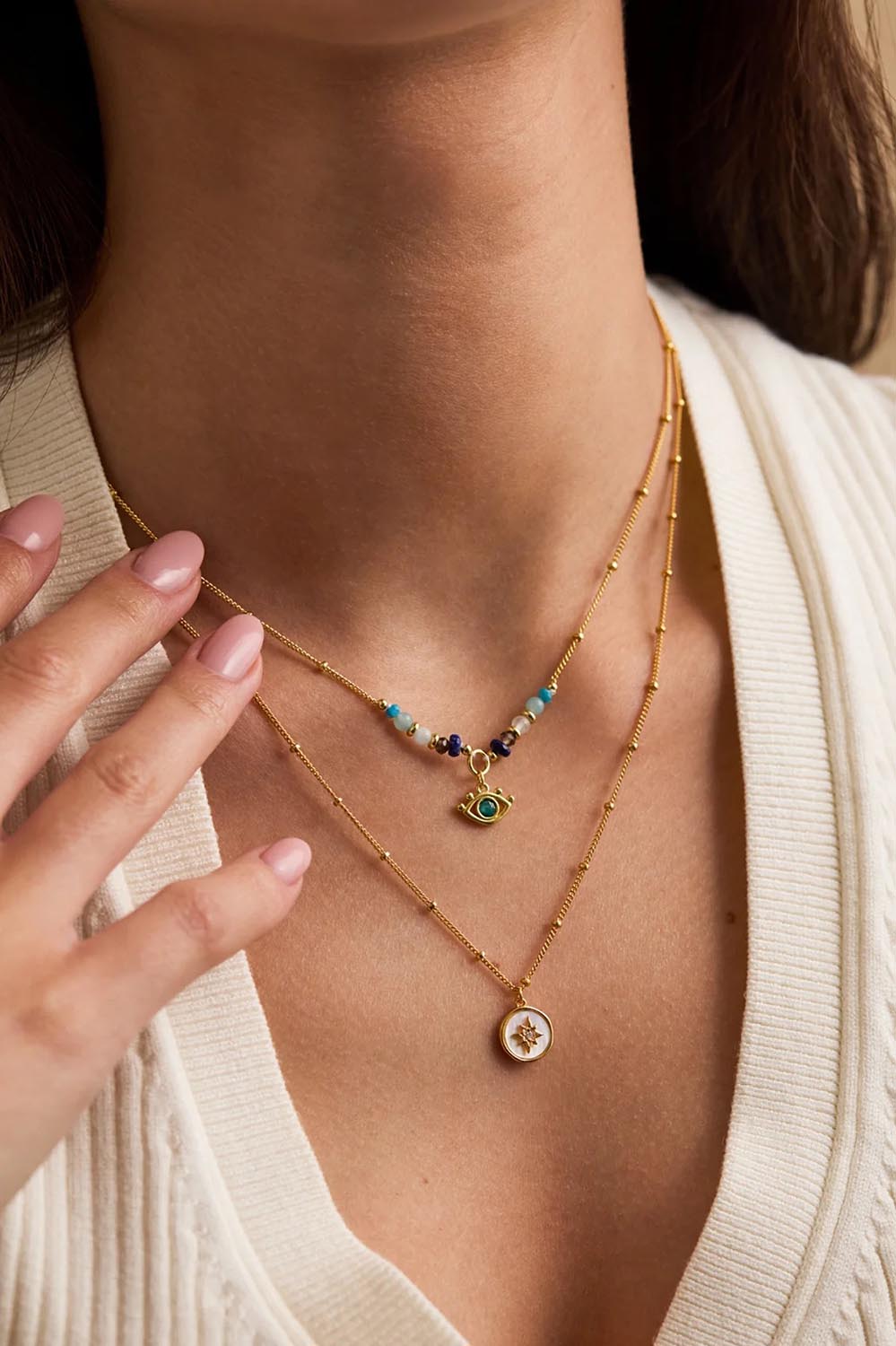 Model Genericm wearing size sample of the North Star Coin Necklace – Gold in colour Gold, in a cropped view