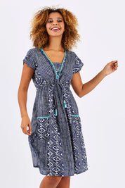 Model Summer wearing size S of the Amber Dress in colour TribNavy (Blue), from the front, cropped image