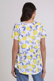 Model Madeline wearing size S of the Here Comes The Summer Cotton Tee in colour Zestlife, from the back