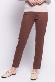 A model wearing the Holey Moleskin Trouser in colour Sepia, from the front, cropped image
