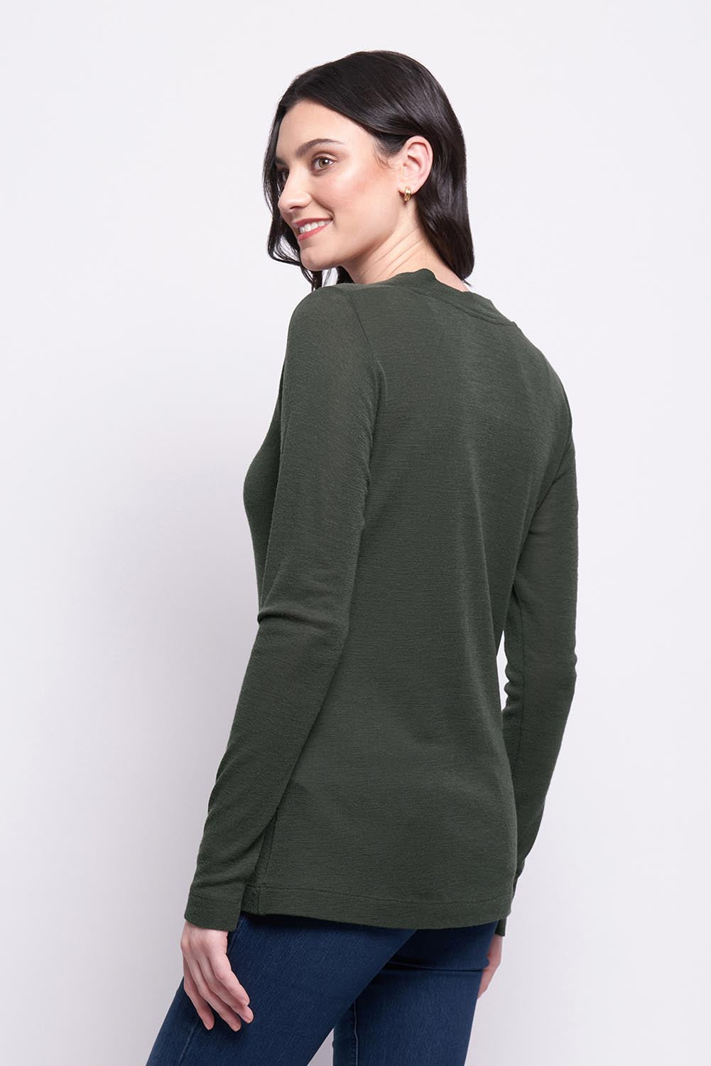 A model wearing the Holy Cowl Wool Top in colour Moss (Green), from the back