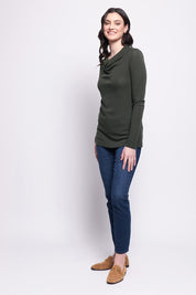 A model wearing the Holy Cowl Wool Top in colour Moss (Green), from the front, showing the whole outfit