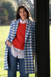 A model wearing the Play The Long Game Coat in colour Bluey (Blue), from the front, showing the whole outfit