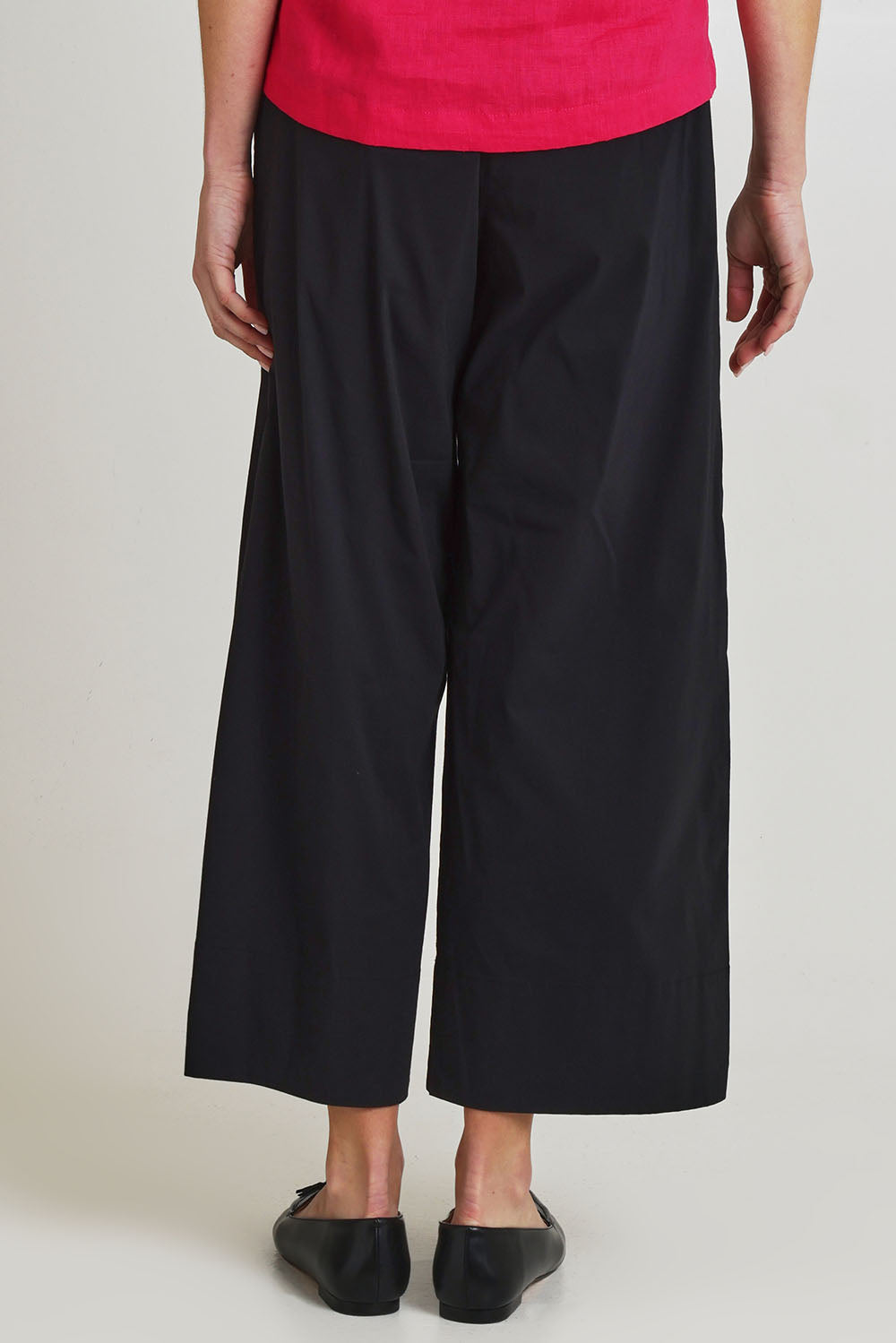 Model Olivia wearing size 10 of the Broad Appeal Pant in colour Black (Black), from the back