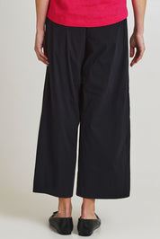Model Olivia wearing size 10 of the Broad Appeal Pant in colour Black (Black), from the back