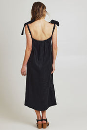 Model Olivia wearing size 10 of the Bali Tie Linen Dress in colour Black (Black), from the back