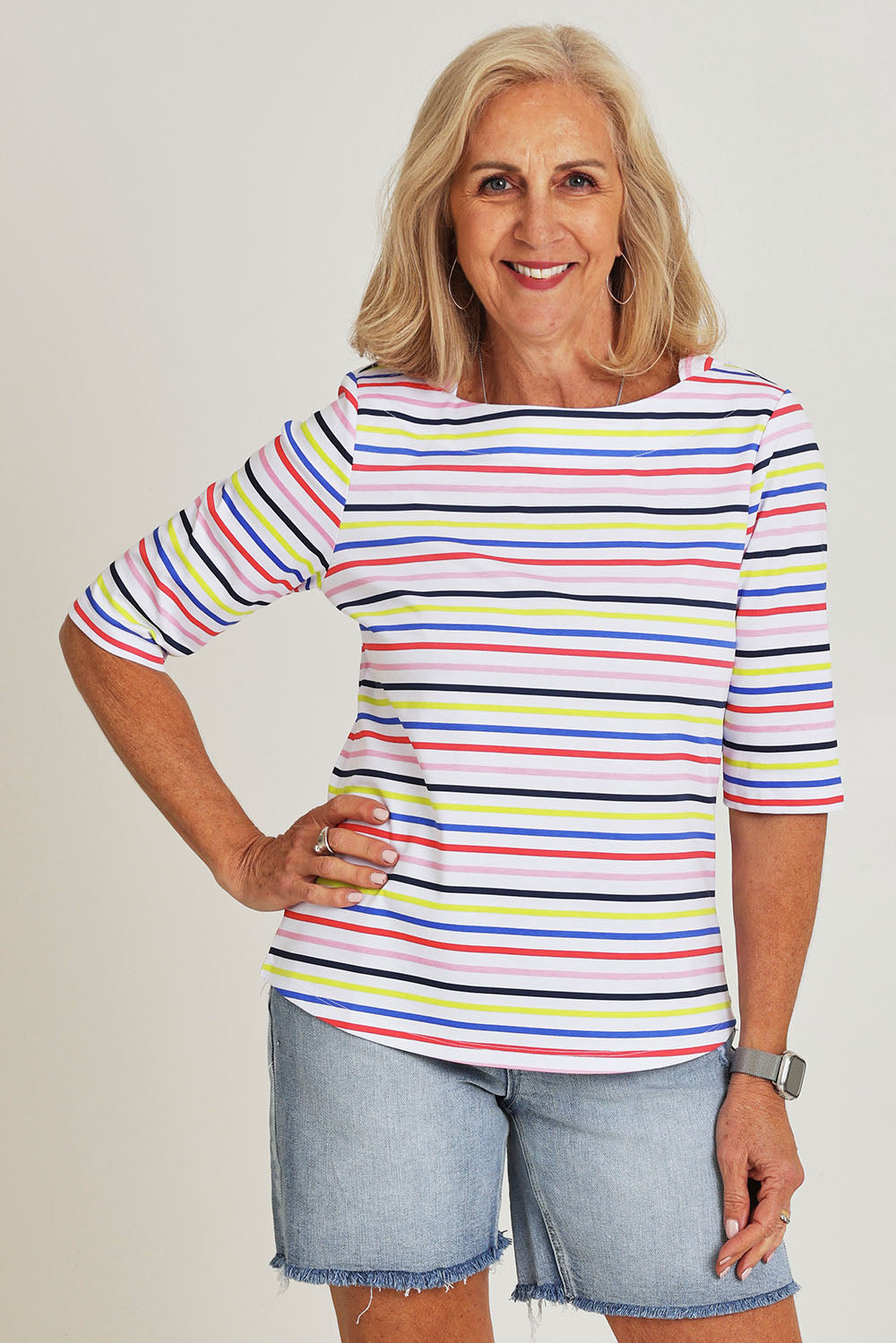 Model Sandy wearing size S of the Even Keel Cotton Top in colour Multistrip (Pink), from the front, cropped image