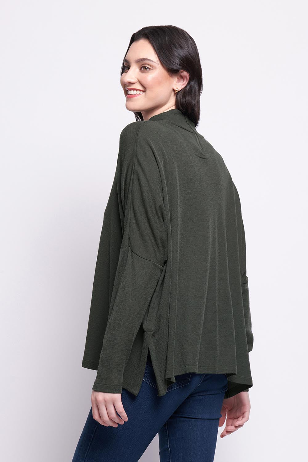 A model wearing the Merino Raisin The Baa Sweater in colour Moss (Green), from the back