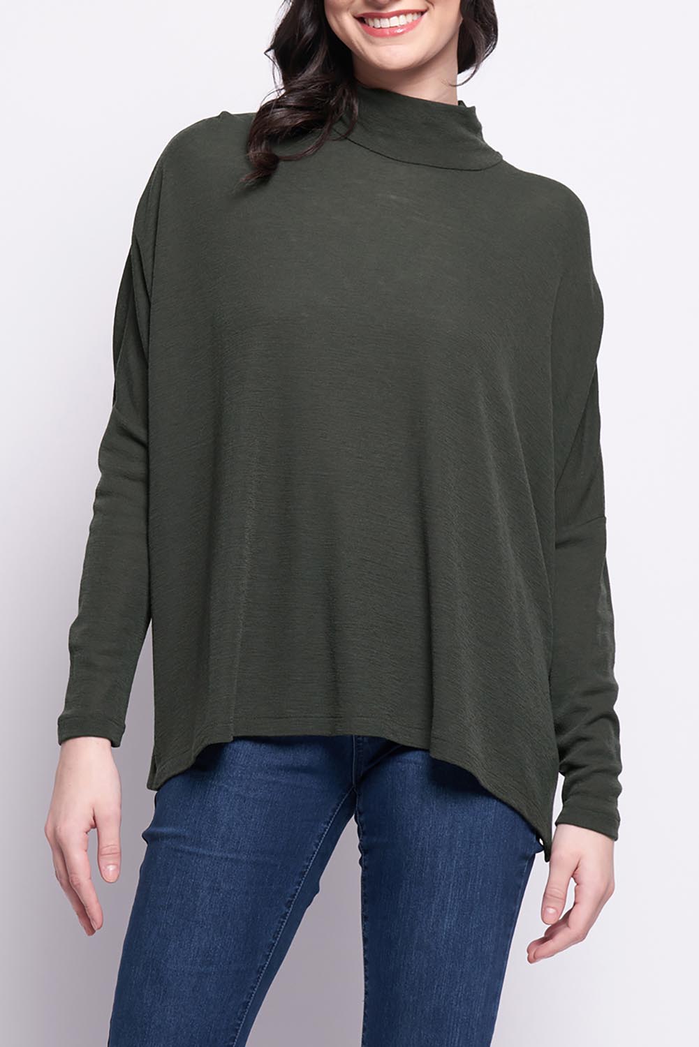 A model wearing the Merino Raisin The Baa Sweater in colour Moss (Green), from the front, cropped image